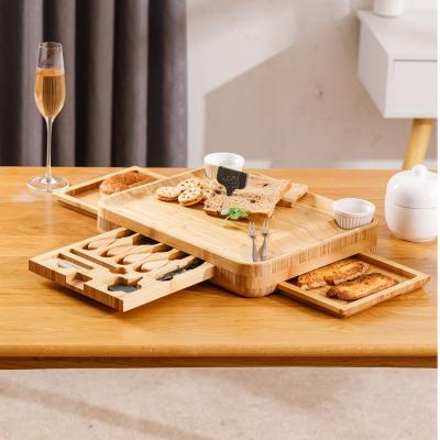 China Sustainable Bamboo Wooden Charcuterie Slide-Out 4 Drawer Magnetic Cheese Board Set With Ceramic Cutlery Bowls And Knife for sale