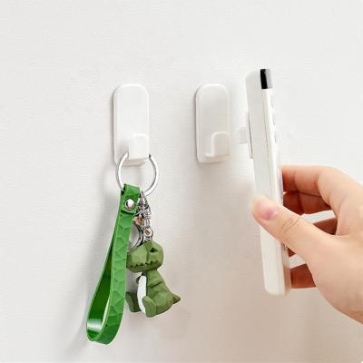 China Viable Wall Mounted Adhesive Hooks Strong Punch Free Door Kitchen Hangs Creative Remote Control Storage Rack Customized Plastic Goods for sale