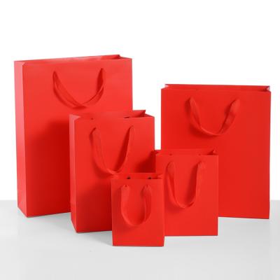 China Customizable Red Color Package Handbag Gift Bag Kraft Paper Bag Food Clothing Handbag Jewelry Wrapping Paper Bag for sale