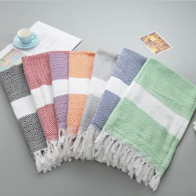 China Compressed custom 100% cotton beach towel turkish pestemal fouta bath towel with tassels for sale