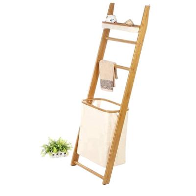 China Sustainable Bamboo Bathroom Wall Standing Ladder Shelf Organization Storage Rack With Hamper Laundry Basket for sale