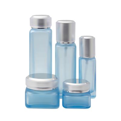 China 100ml Cosmetic Blue Square Glass Cosmetic Lotion Bottle for sale