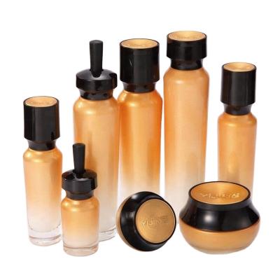 China Gold Cosmetic Small Empty Glass Cosmetic Lotion Jars Wholesale for sale