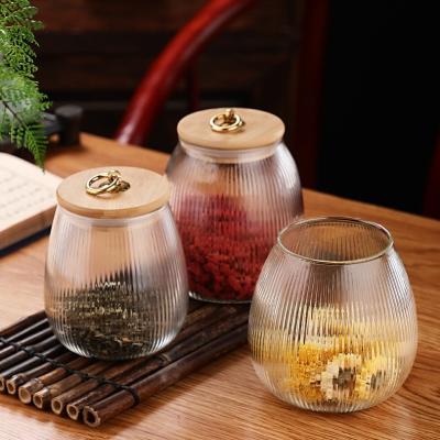 China Viable Bulk Ribbed Details High Borosilicate Glass Jar Bamboo Storage Container Lid With Metal Hanging for sale