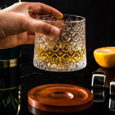 China Rotating Logo Boxes Whiskey Relief Decompression Embossed Crystal Whiskey Glass Cup Rotating Design Custom Glasses Set With Wood Base for sale