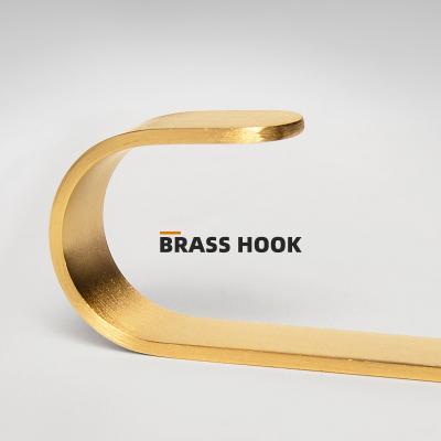 China Modern Brass Non-perforated Gold Hook Nordic Metal Glue Hook Wall Door Coat Rack Creative Strong Hanger for sale