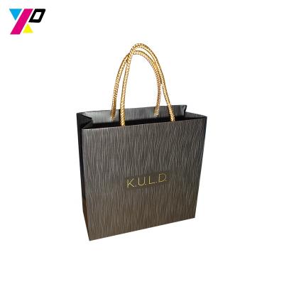 China Recyclable Wholesale Black Custom Design Foil Logo Shopping Paper Bag With Handle For Wedding Party for sale