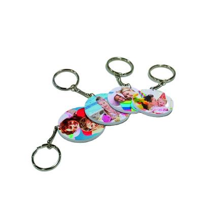 China 39mm Polymer Fashion Key Chains New Arrival Customized Environmentally Friendly Hanging Sublimation Round Key Chain for sale