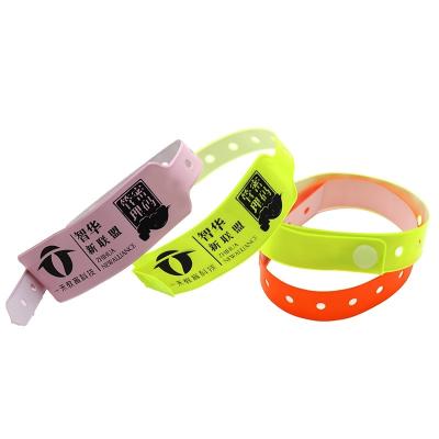 China Pulsera desechable personalizada de color fluorescente de neón plástico vinilo PVC impermeable para eventos de fiesta pulsera con pestañas en venta