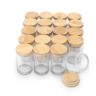 China Household Products Like Glass Jars Clear Matte Frosted Empty Glass Candle Jars With Wooden Lids For Candle Making for sale