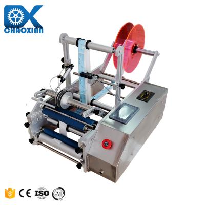 China Semi Automatic Table Top Double Sides Wet Glue Round Bottle Self-Adhesive Labeling Machine for sale