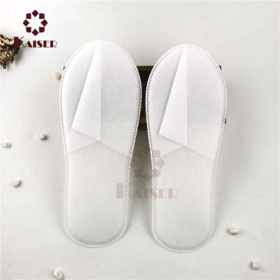 China Cheap Disposable Natural Degradable Hotel Nonwoven Embossed Embossed Slippers Guest Room Disposable Slippers Use Disposable Slippers for sale