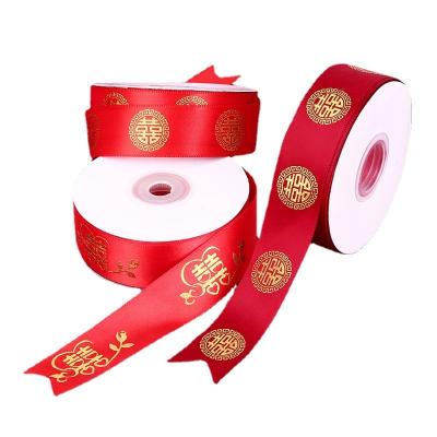 China Viable Wholesale Polyester Bronzing Red Ribbon Wedding Decoration Ribbon Stain 2.5cm Wedding Party Ribbon for sale