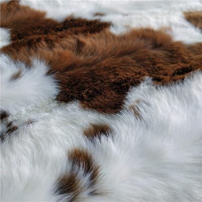 China Embossed Dairy Cow Happy Jacquard Artificial Faux Fur Fabric For Bag Covers for sale