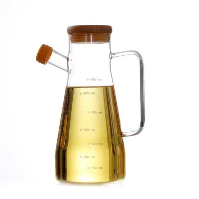 China Dispensing High Quality Measuring Cooking Kitchen Jar Vinegar Oil Dispenser Bottle Glass Jar With Handle Lid for sale