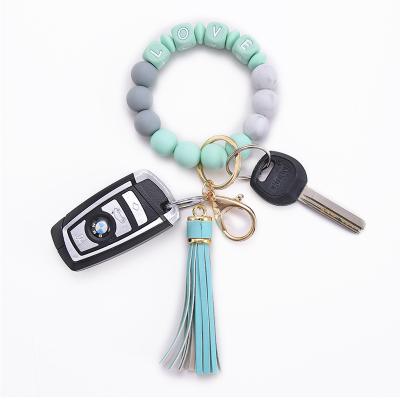 China New LOVE Letter Handmade Punk Creative String Key Ring Silicone Bead Key Ring PU Tassel Leather Bracelet Color Optional for sale