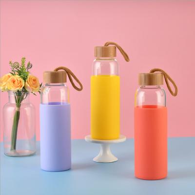 China Viable Glass Water Bottle BPA Free Wide Mouth Tumbler Glass Travel Mug With Silicone Protective Sleeve for sale