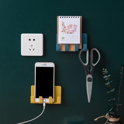 China Viable Living Room Kitchen Self Adhesive Hooks Toilet Mobile Phone Charger Cable Hook Socket Holder for sale