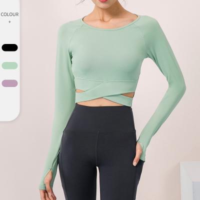 China Crewneck Breathable Stretch Belly Women Belly Cross Cross Fitted Thumb Hole Yoga Long Sleeve Crop Top for sale