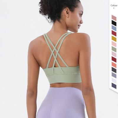 China Breathable Seamless Workout Fitness Active Sports Wear Backless Cut Out Twisted Crop Sexy Cross Back Yoga Bra Top Women for sale