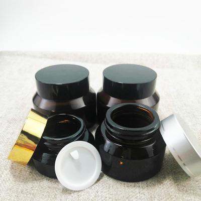 China 15g 30g 50g 1oz Luxury Empty Oblique Shoulder Amber Green Clear Face Eye Cream Cosmetic Glass Jar With Black Plastic Lids for sale