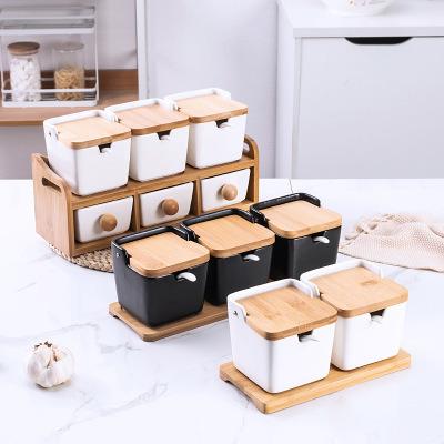 China Sustainable Japanese Seasoning Jar Set Ceramic Salt Jar Black And White Seasoning Jar Bamboo And Wooden Rack for sale