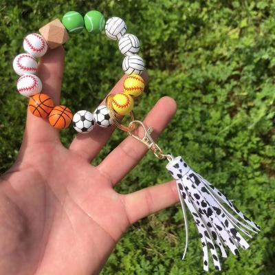 China Fashion Key Ring Wood Bead Tassel Wristband Football Pendant Wrist Support Bracelets Fashion Basketball Key Chain Beads Bracelet for sale