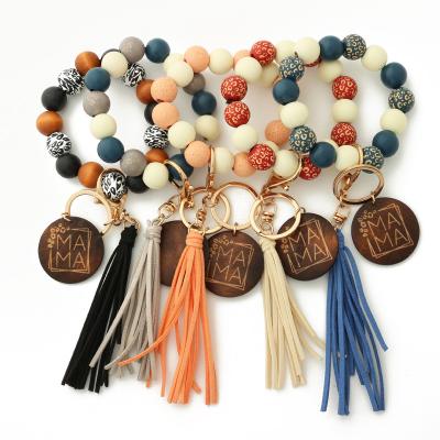 China Fashion Unique Wooden Key Ring Bracelet Wristlet Keychain Beaded Key Bracelet Chains For Women With Leather Tassel for sale