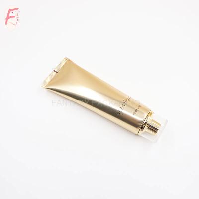 China Cosmetics 100ml 3.52 fl oz Round Shape ABL Aluminum Laminated Tube Mask Cream Container Shiny Gold Packaging Tube With Acrylic Screw Cap for sale