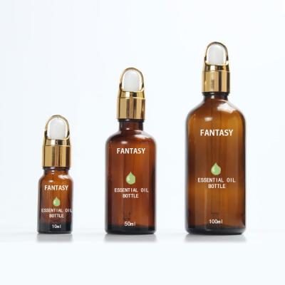 China Cosmetic Luxury Amber Brown Glass Essence Bottle Round Shoulder Bottles Gold Dropper for sale