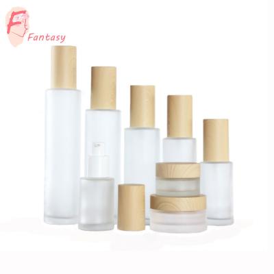 China 20ml 30ml 40ml 60ml 80ml 100ml 120ml eco-friendly cosmetics glass bottle wood packaging with fake pattern wood pump, sprayer for sale