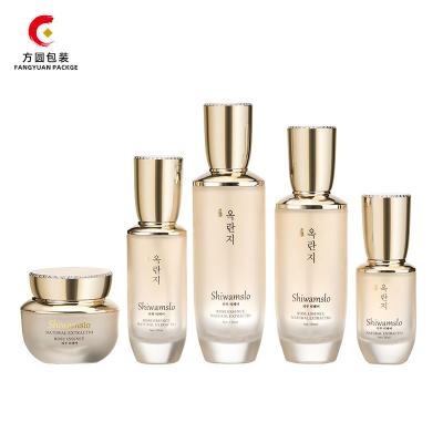 China Wholesale Luxury Personal Skin Care Packaging Glass Empty Packaging Set With Gold Cap Lotion Pump Bottle And Dropper Bottle for sale