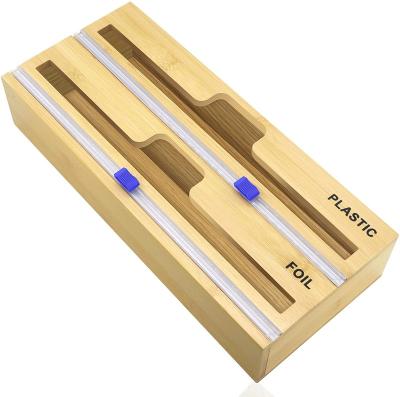 China Sustainable Bamboo Wood Wrap Dispenser With Slide Cutter 2 Slots Cling Cutter Aluminum Foil Organizer Dispenser for sale