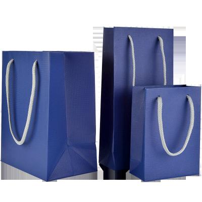 China Recycled Materials Shoes And Apparel Tote Bags Instock Art Paper Gift Bags With Luxury Blue Color Embossed for sale