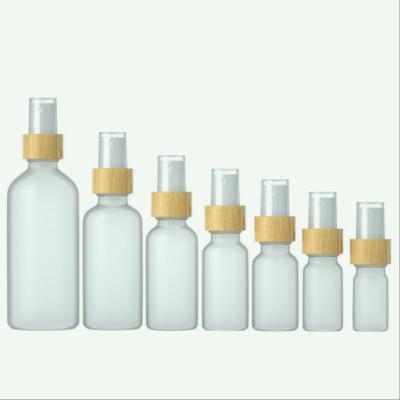 China 5ml10ml15ml20ml30ml50ml100ml Cosmetic Spray Hot Selling Transparent Frosted Glass Bottle With Wooden Cap for sale