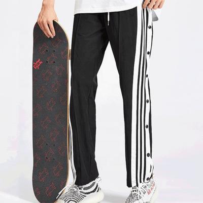 China Breathable Men's Custom Street Hip Hop Skateboard Track Pants with Side Stripe and Buttons for sale