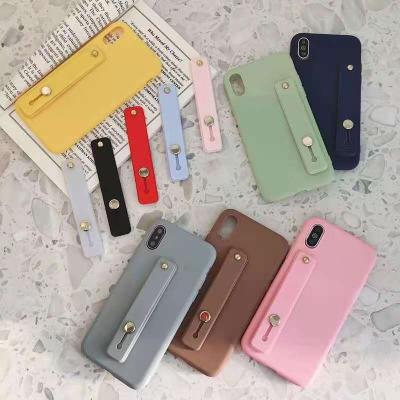 China Ultra-thin candy color mobile phone case wrist strap bracket push up stretch silicone color daily firm cover device for sale