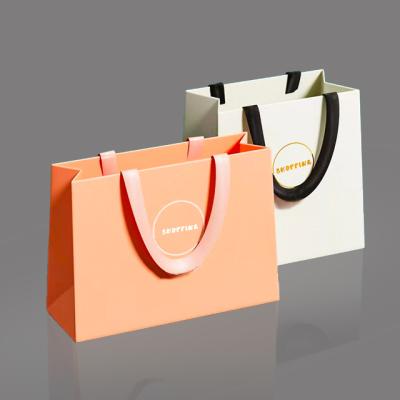 China Custom Printed Recyclable Paper Bags Luxury Boutique Shopping Paper Bag Logo Apparel Gift Bag With Ribbon Rope for sale