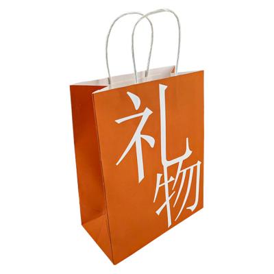 China Recycled Materials Gift Bag In Stock White Kraft Paper Packaging Bag With Handle Business Shopping Take Away Bag for sale