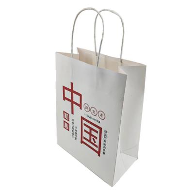 China Recycled Materials China Gift Bag In Stock White Kraft Paper Packaging Bag With Handle Business Shopping Take Away Bag for sale