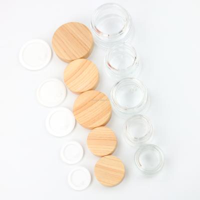 China Personal Care Empty 30ml Clear Glass Jar And Bottles Bulk 30g 1OZ Transparent Glass Jars With Bamboo Grain Lid For Skin Care Packaging for sale