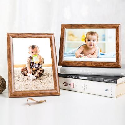 China Plastic imitation wooden studio photo frame Baby one-month-old photo frame Studio promotion high quality boutique picture frame wall for sale