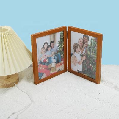 China Modern Creative Simplicity Plastic Photo Frame Combination Folding Double Screen 8 Inch Multifunctional Plastic Photo Frame Table Decoration View for sale