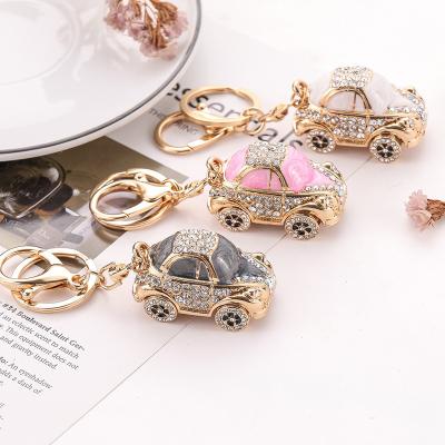 China Bag Car Pendant Accessories Promotional Cartoon Anime Hollow Out Beetle Car Keychain Diamond Inlay Mini Metal Keychains For Car Bags Hanging As Gift for sale