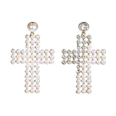 China Simple Creative Stitched Cross Stud Earrings Personalized Half Pearl Diamond Dangle Earrings for sale