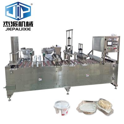 China Automatic Oat Cap Measuring Cup Quantitative Filling Sealing Machine with Spoon Feeding for sale