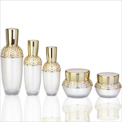 China Cosmetic Luxury golden pattern jar low quantity acrylic plastic cosmetic cream packing jar/bottle with pump/sprayer 30ml 50ml 100ml for sale