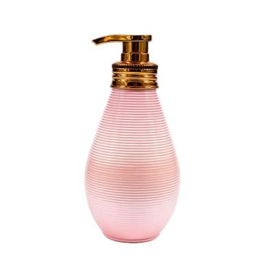 China BEAUTY PACKAGING custom 400ML 13.5OZ unique shape pink color cosmetic body lotion packing gold pump bottle for sale