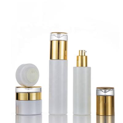 China 20ml 30ml 50ml 60ml 80ml 100ml 120ml Cosmetic Packaging Empty Clear White Glass Pump Bottle With Gold Cap for sale