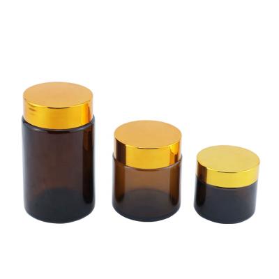 China Cosmetic Packaging 60ml 100ml 200ml Amber Glass Cream Jar With Gold Empty Lid For Cosmetic Packaging for sale